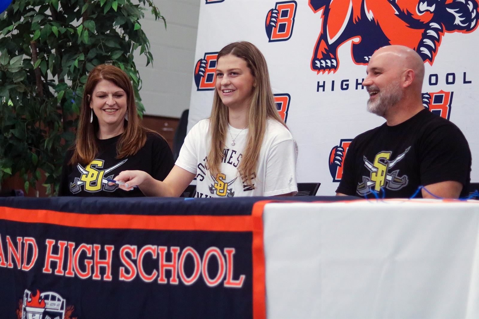 Bridgeland High School senior Emily Marks, seated center, poses with his family after signing a letter of intent.